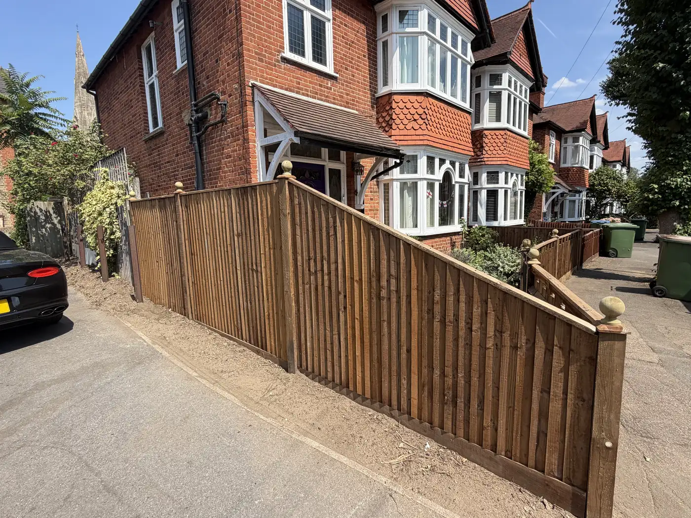 New closeboard fencing with ball-top posts installed along a front garden boundary at a period property New closeboard fencing with ball-top posts installed along a front garden boundary at a period property